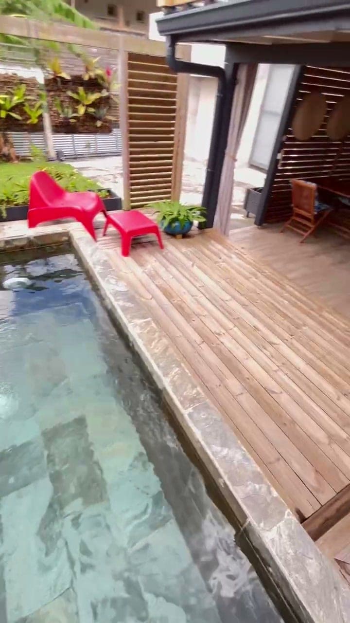 Le deck en bois le long du bac à punch, deux chaises rouges