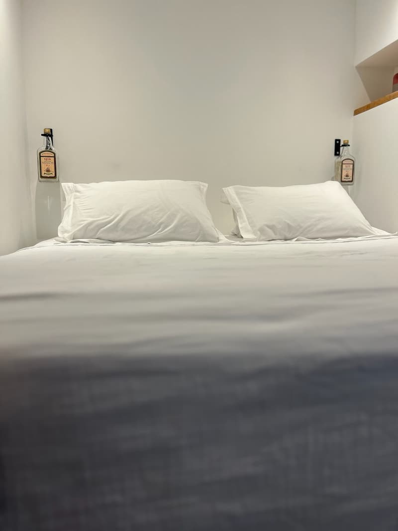 The bed, fresh white sheets and pillows