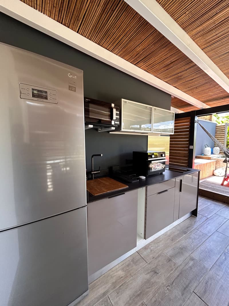 The outdoor kitchen: fridge, countertop and storage
