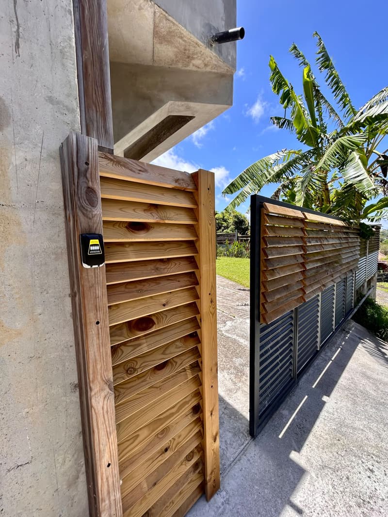 The suite's wooden gate and the garden